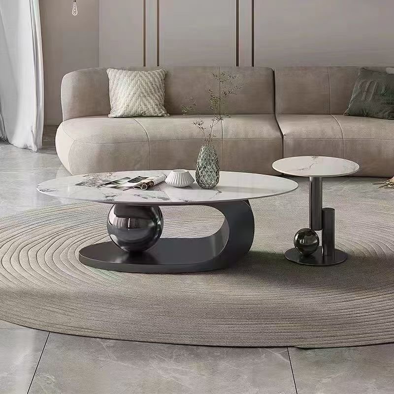 H06965e2c4eca4b8cbea04a9eda9ae241G MODERN MARBLE OVAL CENTER TABLE WITH SCULPTURAL METALLIC BASE DESIGN - Image 1